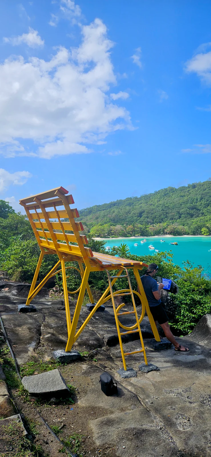 The famous yellow Bench of Happy Thoughts, a unique photo spot in Mahe.