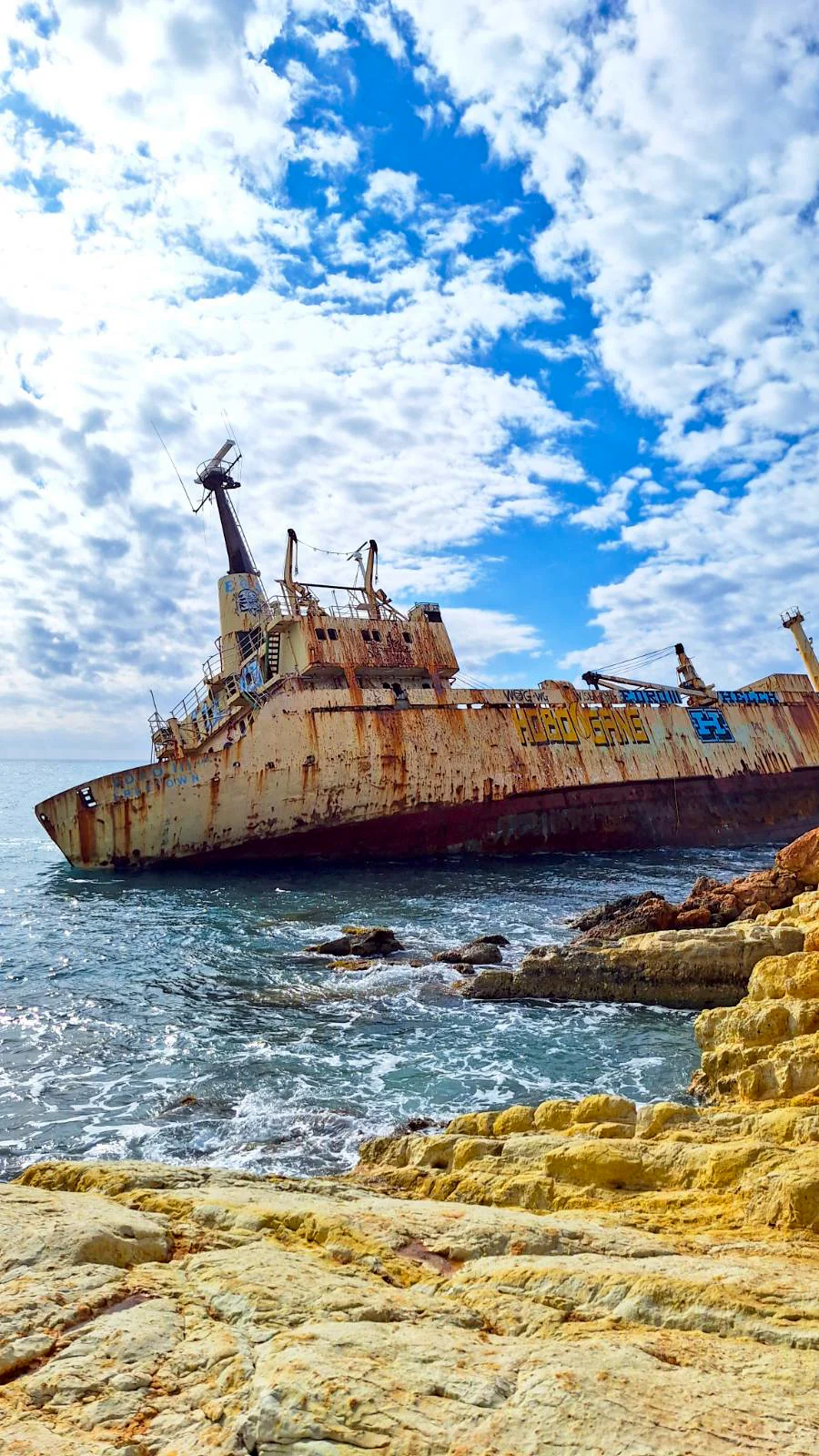 The rusted EDRO III shipwreck sitting on the rocks of the Paphos coastline, Cyprus.