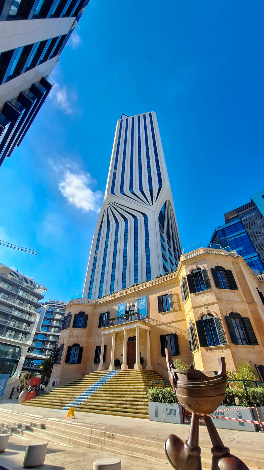 Nowoczesna wieża Mercury Tower projektu Zahy Hadid wznosząca się nad tradycyjną maltańską willą w St. Julian's.