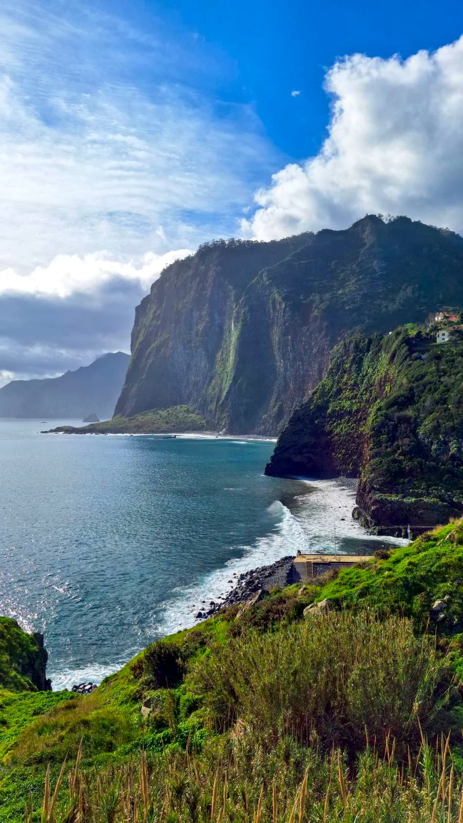 Dramatic vertical view of the triangular cliffs at Miradouro do Guindaste, Madeira.