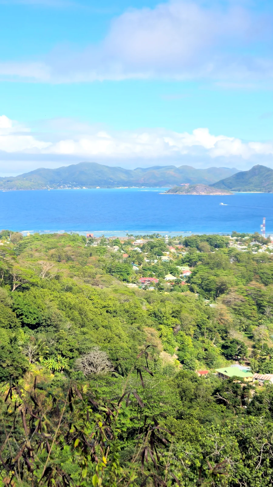 Panoramic view of the turquoise ocean and neighboring islands from the Nid d'Aigle viewpoint on La Digue.