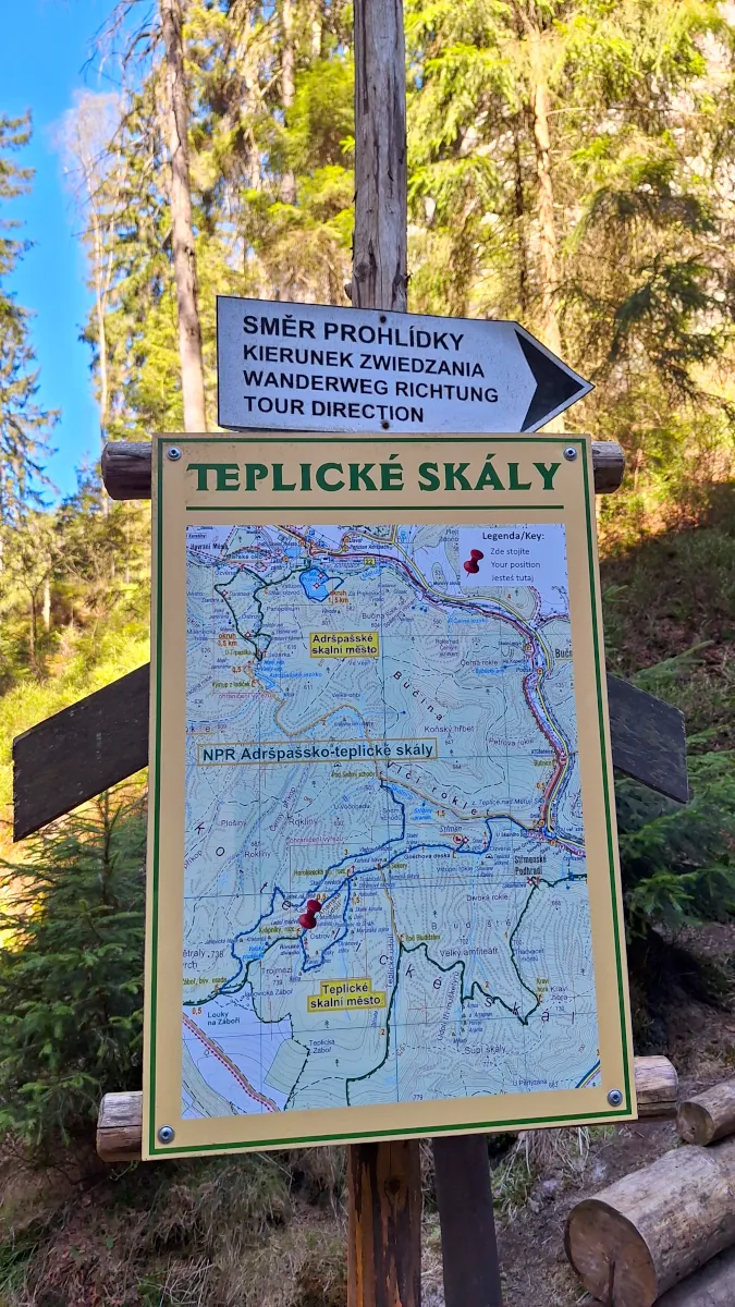 Informational sign with a hiking map at the entrance to Teplice Rocks, showing routes for both Adršpach and Teplice rock cities.