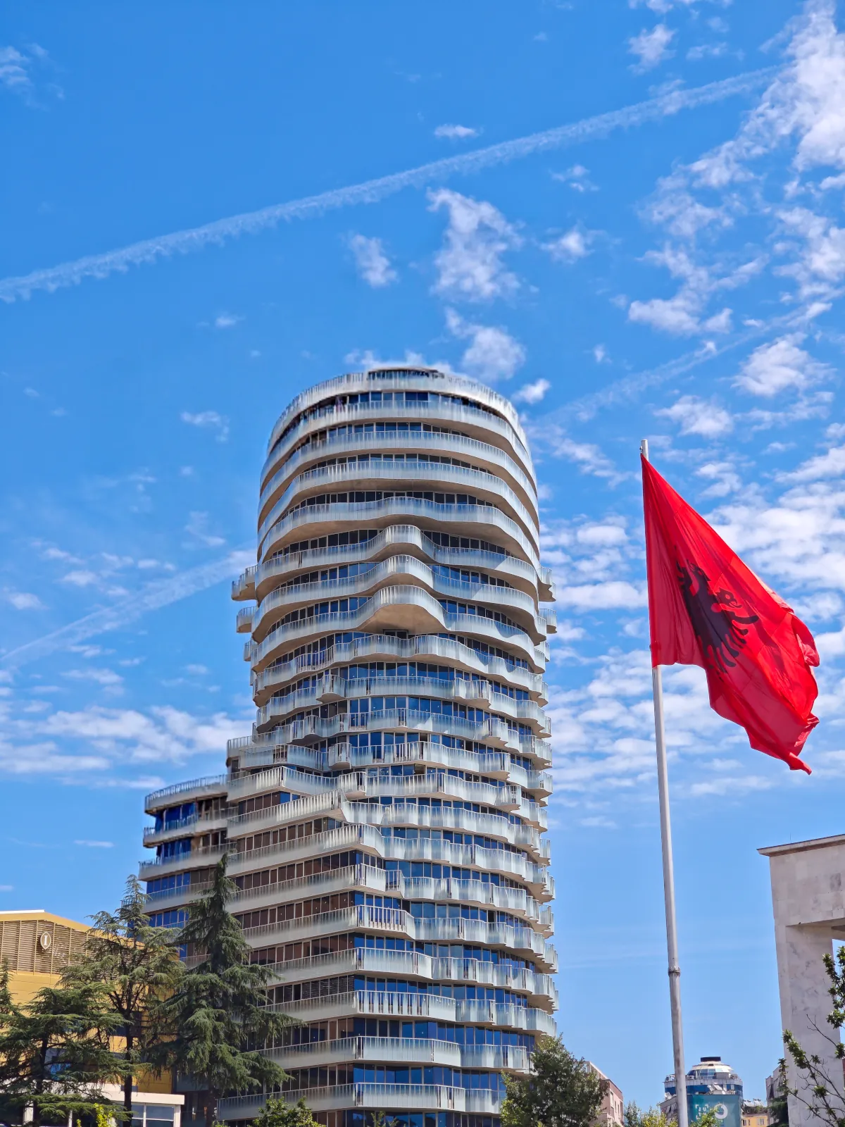 Modern architectural skyscraper known as 'Tirana Rock' standing next to the historic center of Tirana, Albania.