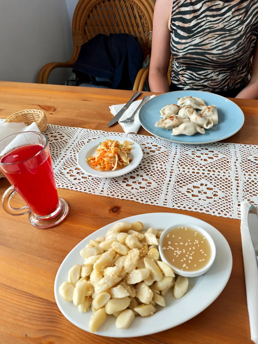 Traditional Polish dumplings (pierogi) and sweet lazy dumplings (pierogi leniwe) with agave syrup served at Pod Przykrywką restaurant in Wrocław.
