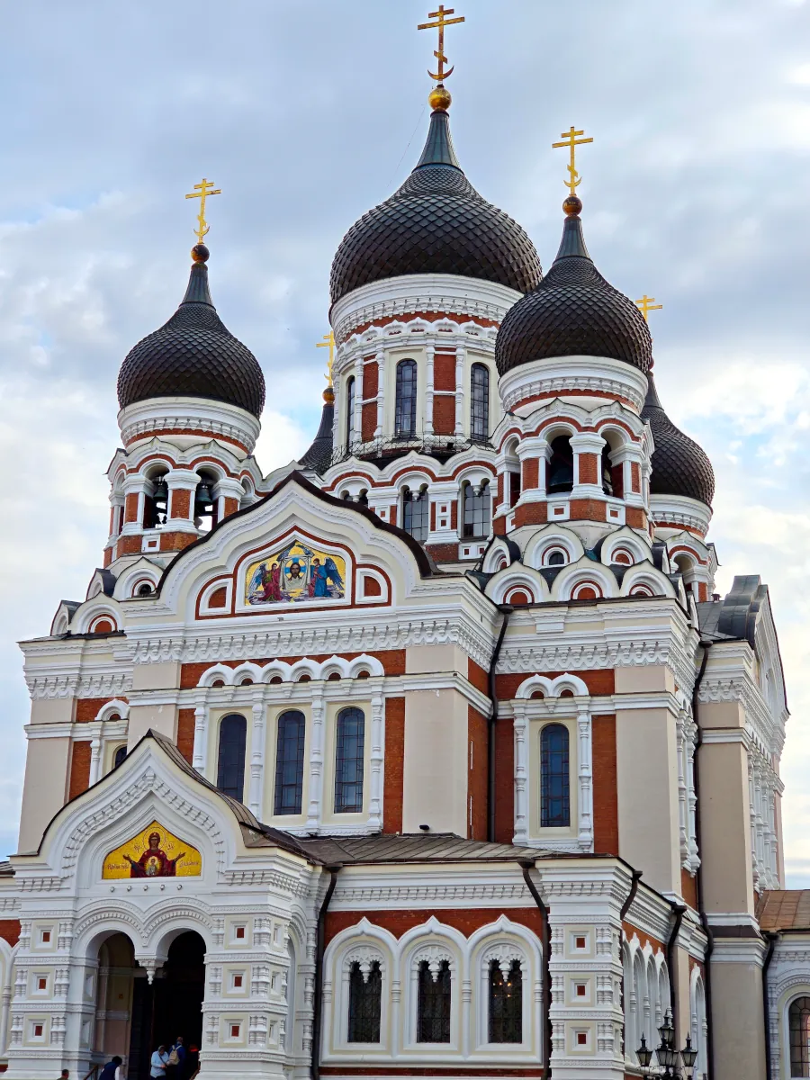Detailed architectural view of the black onion domes and ornate facade of Alexander Nevsky Cathedral on Toompea Hill in Tallinn, Estonia.
