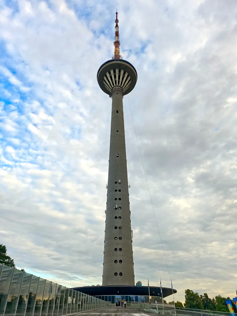 Low-angle perspective of the 314-meter Tallinn TV Tower (Tallinna teletorn) against a cloudy sky in Pirita, Estonia.